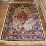 A red ground Kashmir-style drawing room rug with double border, multicoloured floral and foliate