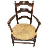 An Arts and Crafts oak and elm Sussex chair with ladder back support with finials to the uprights,