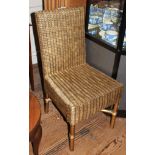 A contemporary gold painted occasional chair with bamboo effect frame and wicker supported seat with