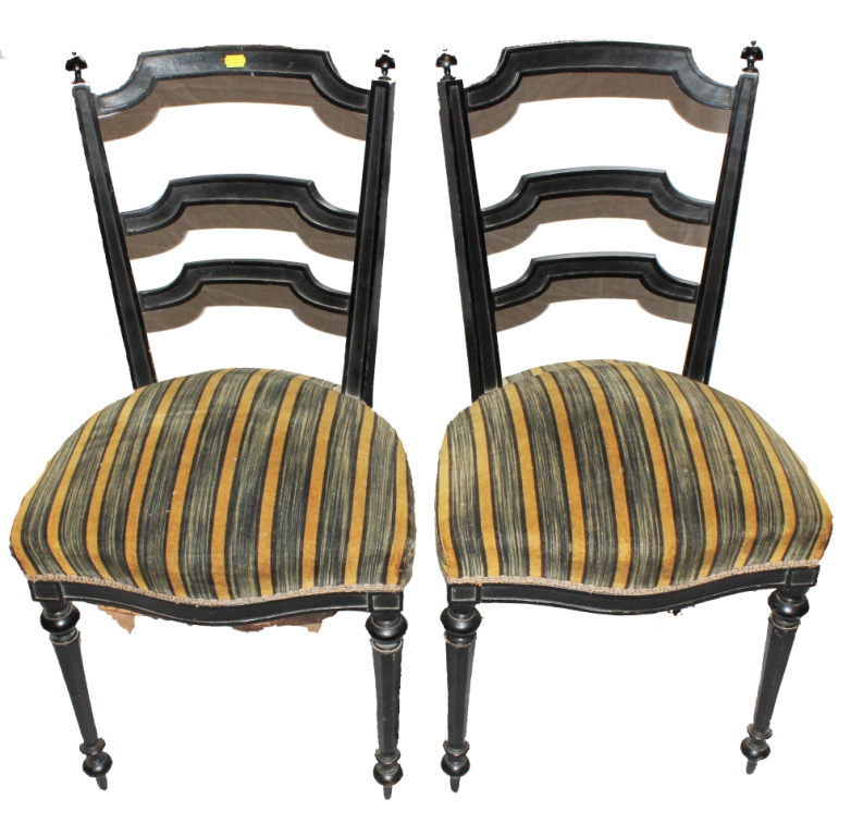 A pair of 19th century lacquered dining or drawing room chairs with ladder back supports, finials to