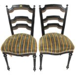 A pair of 19th century lacquered dining or drawing room chairs with ladder back supports, finials to