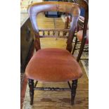 A set of four Victorian mahogany spoon back dining chairs, shaped top rails with spindle supports,