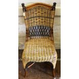 A bamboo framed occasional chair with wicker support and seat, arched top rail, raised on sabre legs