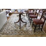 A Middle Eastern-style ivory ground drawing room rug with multicoloured floral and foliate designs