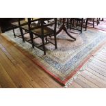 A Indian pink ground hand knotted wool pile drawing room carpet or rug with treble border,