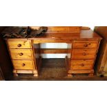 A 19th century-style pine twin pedestal writing table with moulded top, with three graduated drawers