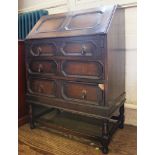 An early 20th century oak stained bureau with fold down front, fitted interior with three graduating