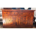 A contemporary teak-stained sideboard of oblong form with shaped top, two drawers under with metal