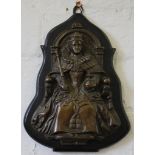 A Victorian bronze plaque mounted on a wooden base of a seated queen holding a sceptre and globe,