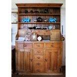 A 19th century Welsh pine dresser with shaped cornice with two plate shelves to the upper section