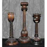 Three odd African blackwood candlesticks, 18cm - 26cm high  The Art Deco Carvings of W. G.