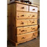 A pine chest of two small and four long drawers with moulded top, circular handles on a square