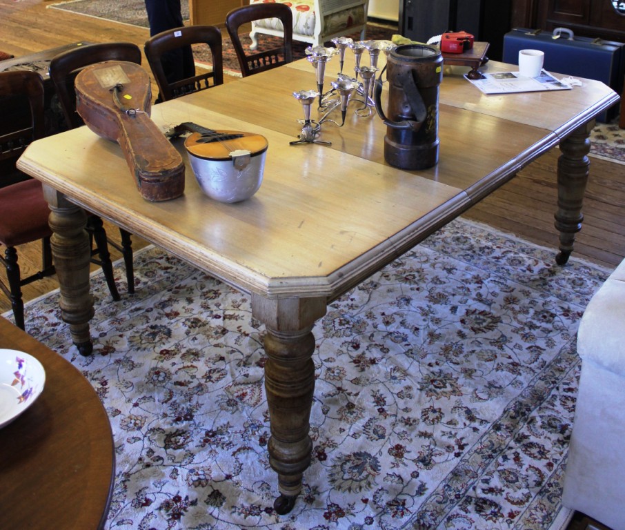 A Victorian mahogany extending dining table with moulded top, canted corners, raised on turned