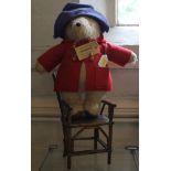 Paddington Bear by Gabrielle Designs with Darkest Peru luggage label, 38cm and a wooden doll's chair
