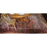 A Middle Eastern-style red-ground hand knotted wool pile drawing room rug with treble border,