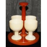 Four ivory egg cups on a catalin stand, 13.5cm  The Art Deco Carvings of W. G. Collins (1872-1959)
