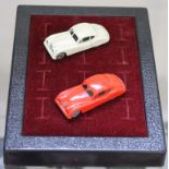 Two Matchbox No. 32 Jaguar XK 140 Coupes, one off-white with metal wheels, one in rare red with