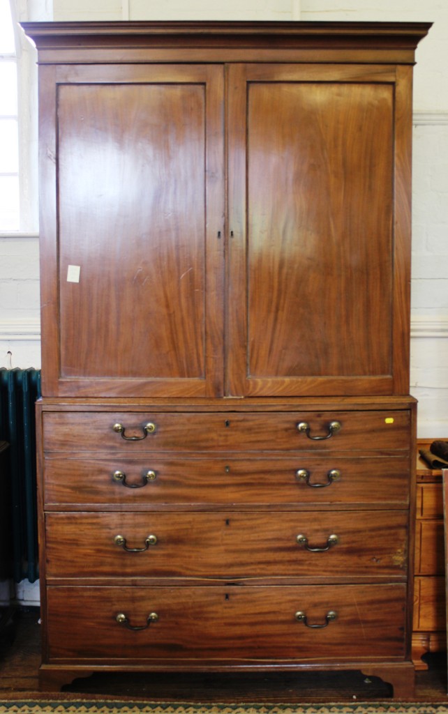 A Georgian mahogany linen press with moulded cornice, twin panelled door, the interior fitted for