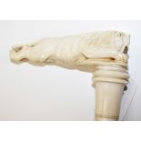 An ivory walking cane having a carved lion handle, circa 1880