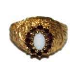 A 9 carat gold garnet and opal ring