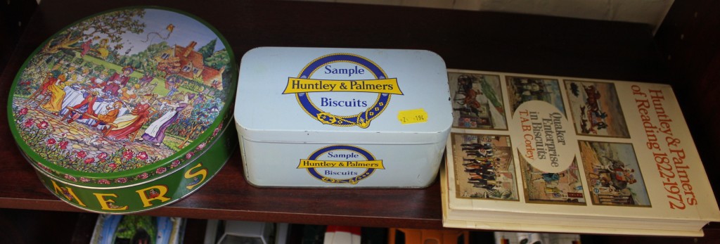 A mid 20th century circular Huntley & Palmers biscuit tin, depicting family picnic in garden (