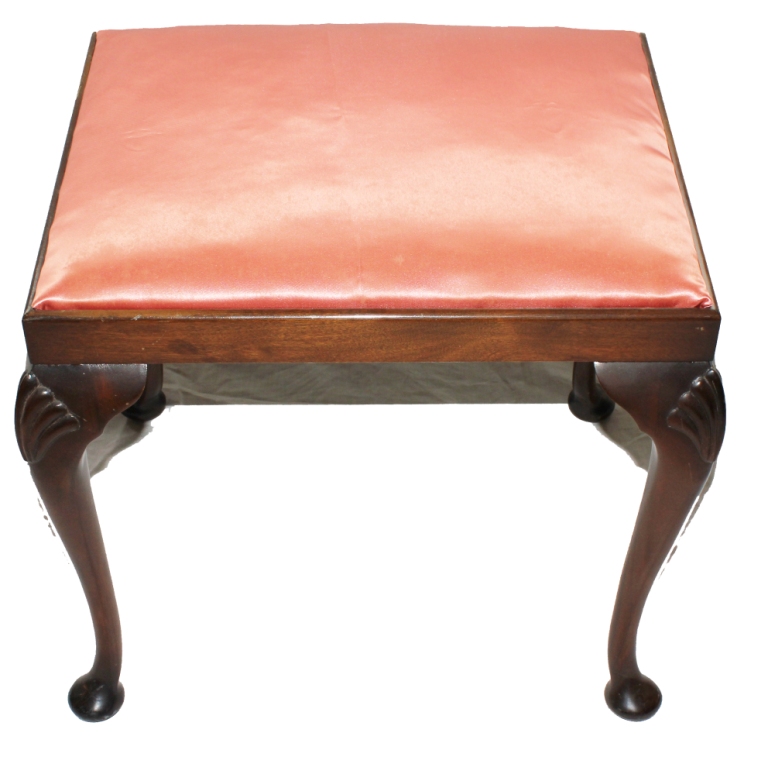 A Georgian-style oblong mahogany framed dressing stool with silk upholstered seat, carved shell