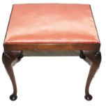 A Georgian-style oblong mahogany framed dressing stool with silk upholstered seat, carved shell