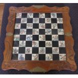 An early 20th century hardwood chess set with incised carving to the rim of the chess board, two