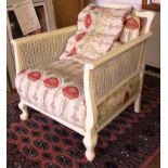An ivory painted Bergere-style conservatory arm chair with William Morris-style fabric upholstery,