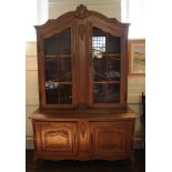 A 19th century-style Continental display cabinet with 'C' scroll decoration to the cornice, shell