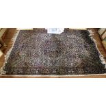 A Middle Eastern hand knotted wool floor rug with treble border, with multicoloured floral and