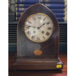 An Edwardian mahogany mantle clock with overall string inlay, circular dial with Roman numerals on a