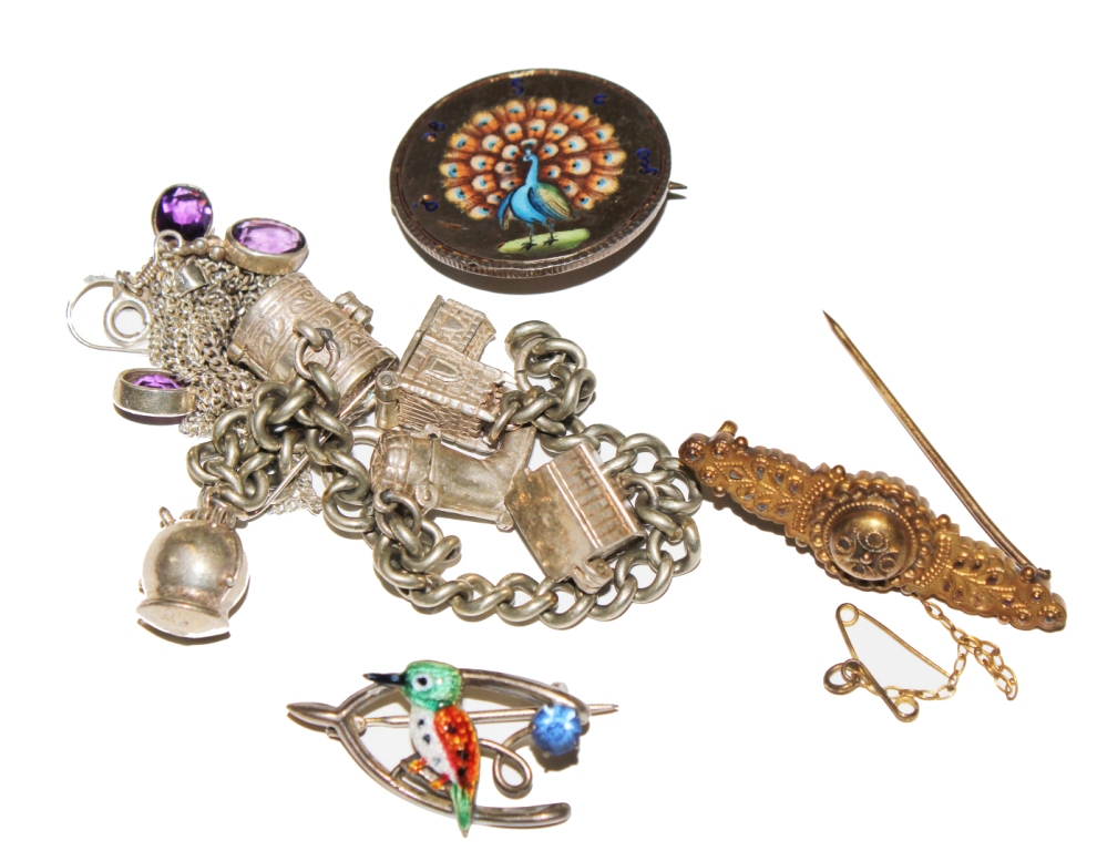 A silver charm bracelet, etc