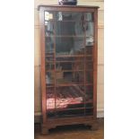 An Edwardian mahogany display cabinet with moulded top, single astragal door, adjustable shelved