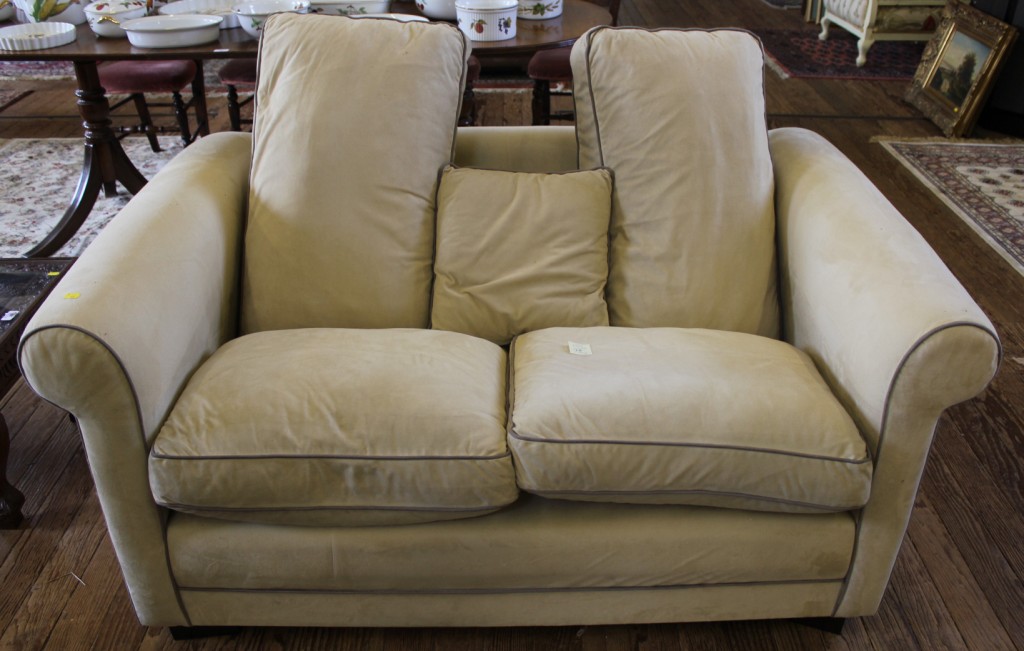 A contemporary fabric upholstered two seat sofa in cream, suedette, with removable cushions,