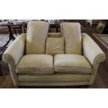 A contemporary fabric upholstered two seat sofa in cream, suedette, with removable cushions,