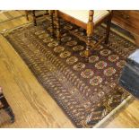 A Turkish hand-woven wool rug with treble border, multicoloured isometric design and short fringe,