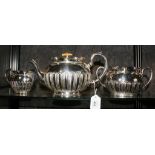 A late Victorian silver plated three piece tea service comprising tea pot, sugar bowl and cream jug