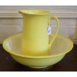 A vintage circular wash bowl and ewer in sunburst yellow