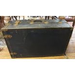 An early 20th century oblong metal travelling trunk with metal fittings and leather handles, 86cm