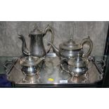 A 19th century style silver plated four piece tea service on matching tray with twin handles