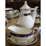 A Viceroy Royal Grafton ninety-seven piece dinner and tea service with blue and gold rims