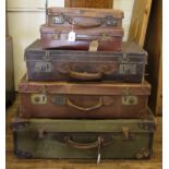 An assortment of five leather travelling trunks, suit cases, attaches, etc