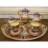 A late 19th century Viennese 'Tea for Two' service, consisting of two cups, two saucers, coffee pot,