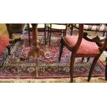 A Kashmir-style red-ground double border, multicoloured floral and foliate design drawing room