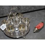 A silver plated egg cup holder with highly pierced border and a cast silver plate pin cushion