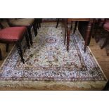 A Kashmir-style ivory-ground double border multicoloured floral and foliate drawing room rug with