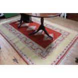 A Turkish yellow-ground hand-knotted wool drawing room rug with multicoloured isometric designs with