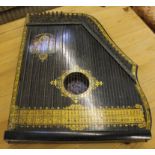 An Anglo American guitar-Zither, ebonized frame with gilt lettering and border and manufacturer's