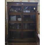 An mid-20th century oak stained Minty Oxford four tier bookcase with shaped top, glazed twin doors